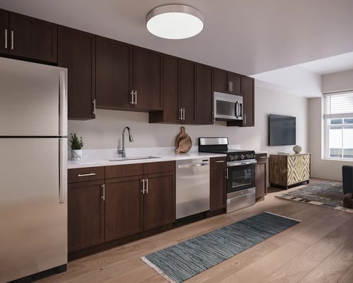A modern kitchen with wooden cabinets and stainless steel appliances at Oskamp Flats Apartments, Ohio, 45202