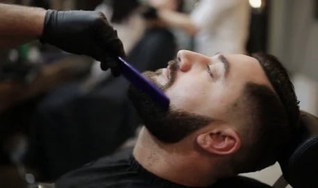 Man getting a hair and beard cut
