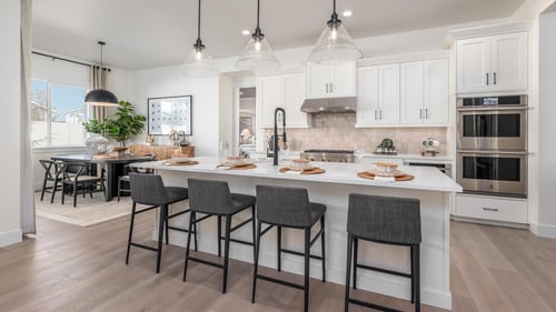 Chef inspired kitchen with gas range, large center island, and abundant cabinet space