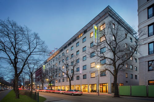Holiday Inn Express on a broad, tree-lined boulevard in Berlin.