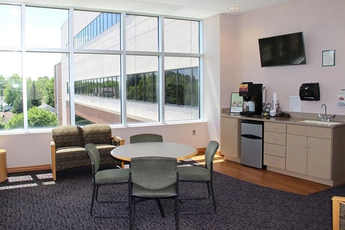 The visitor's lobby as you enter the Women's Center with a table and chairs as well as a counter with coffee pot