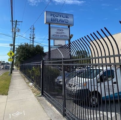 Fence company sign and trucks