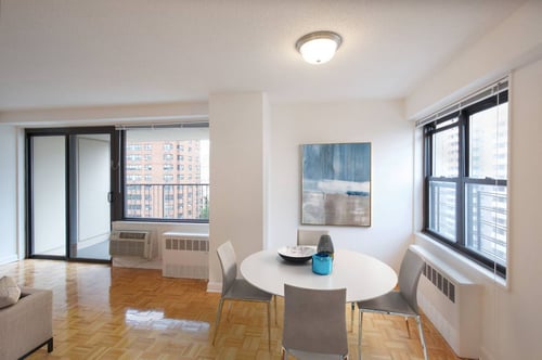 Dining area with air conditioner and framed art