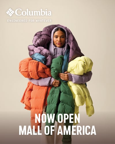 Woman holding jackets.