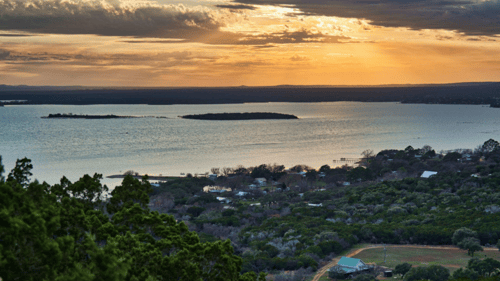 sunset over large body of water