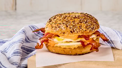 NEW All-American signature Egg Sandwich! 
Two decadent layers of Grilled Eggs, American Cheese, and Bacon with Chipotle Mayo on an Everything Bagel!