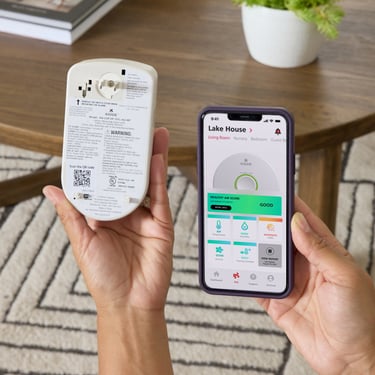 person installing a CO+IAQ device using their mobile phone and Kidde app