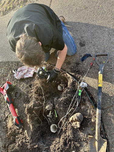 Bluefrog Plumbing + Drain technician inspecting exposed underground plumbing pipes during a residential plumbing repair.