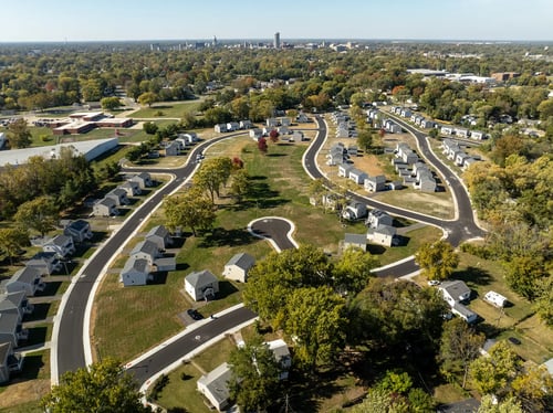 A bird's eye view of a residential area with curved roads and houses at Poplar Place Apartments, Illinois