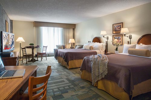 A hotel room with two beds inside The Iron Blosam