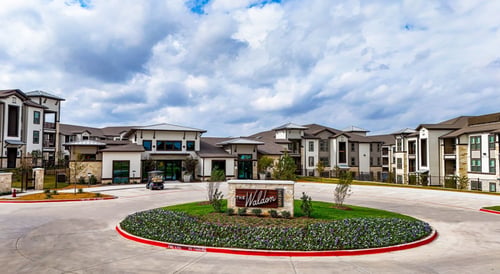 The Waldon apartments in Melissa, TX exterior view with leasing office, landscaped entrance, and modern buildings