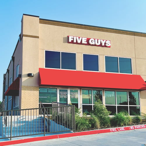 Exterior photograph of the Five Guys restaurant at 4724 Lakeview Parkway in Rowlett Texas.