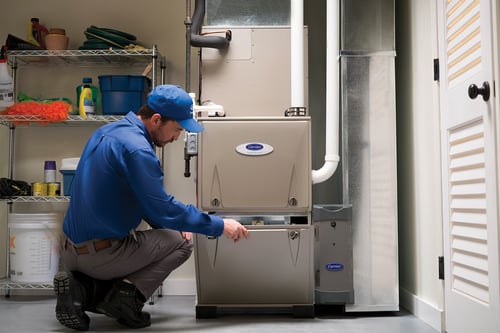 A Carrier dealer performing furnace repair and service.