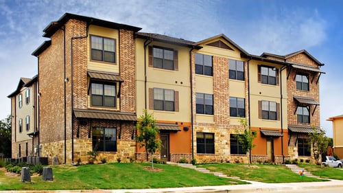 A large brick apartment building with multiple windows and balconies at Centre Place Apartments, Texas, 76205