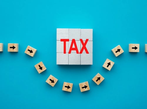 Wooden blocks spelling out "tax".