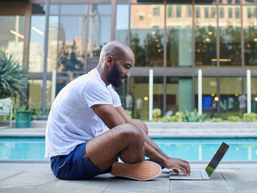 Man using Quantum Fiber internet at his apartment near the pool