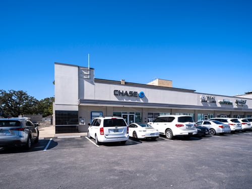 White cars lining the front entrance of Chase Bank on a clear day