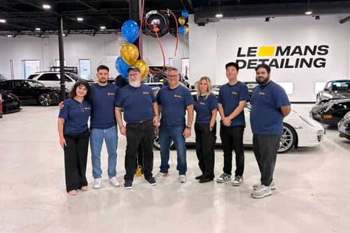 Wagman Daghlian team posing at Le Mans Detailing in Wealth & Wheels custom t-shirts