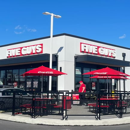 Exterior photograph of the Five Guys restaurant at 24 Terroso Way in Inwood West Virginia.