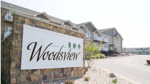 Woodsview Sign in front of building
