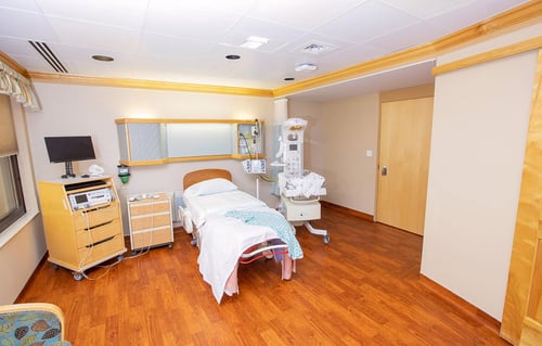 Alternate view of the labor and delivery room showing monitoring equipment and birthing bed