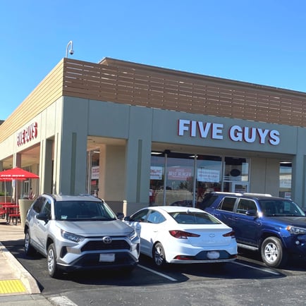 Exterior photograph of the entrance to the Five Guys restaurant at 1201 Marina Boulevard in San Leandro California.