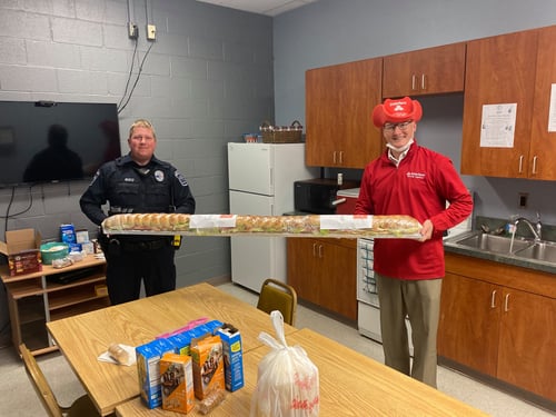 Agent Josh donating sub to police officers