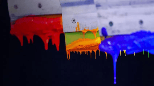 closeup of different ink colors on a screen-printing machine