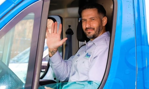 plumber waving in van