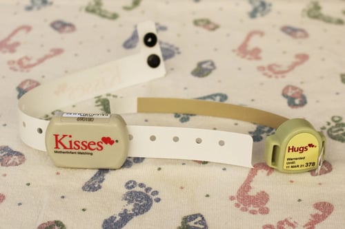 A close up of the HUGs and KISSES tags that help protect both moms and infants