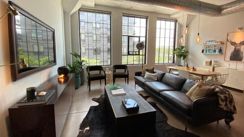 A living room with a black couch and a black rug at Gurley Lofts, Minneapolis, MN, 55401