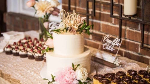 Two tier wedding cake and variety of cupcakes