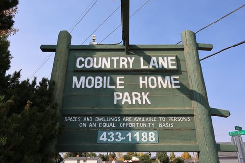 the sign for county lane mobile home park