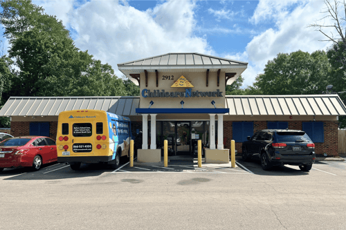Exterior of a school building with brick walls and a main entrance.