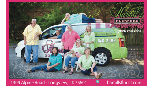 staff sitting in front of business vehicle