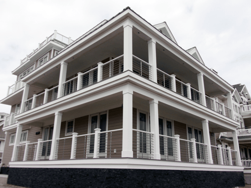 Beautiful, high-quality railings, pergolas, fencing, and PVC specialty products from Phoenix Manufacturing. Horizontal VueTube railings in Anodized Silver with White PVC posts on a two-story wrap around balcony.