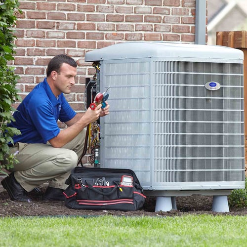 A Carrier dealer performs air conditioner repair and service