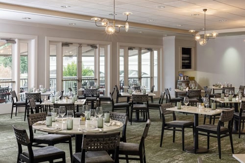 Spacious indoor dining room at The Grill at Silverado with modern decor and full table settings.