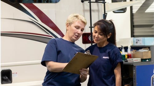 camping world service center workers discussing an rv order