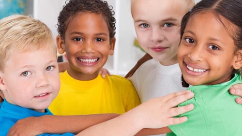 Four small children hugging