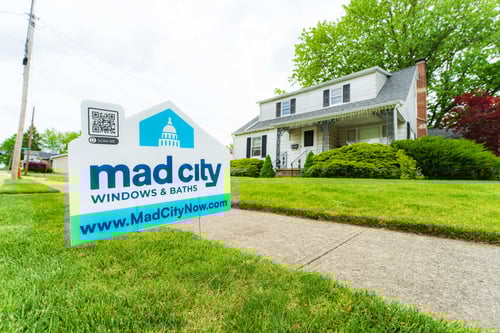 Mad City Windows & Baths sign on the front yard of a newly remodeled home