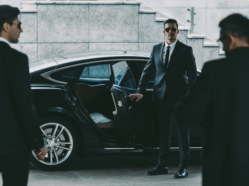 Security agent opening car door