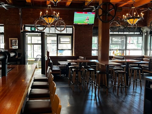 Interior of Swans Pub Victoria BC with bar seating and sports TVs.