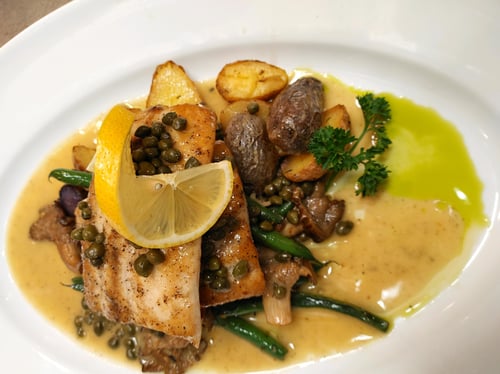 Island Mahi Mahi Pan Seared with a Lemon Caper Butter Sauce served with Sautéed Green Beans and Mushrooms over Garlic Oven Roasted Fingerling Potatoes