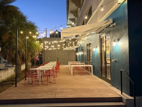 Patio table and chairs with glow lights and greenery