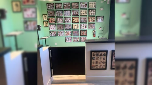 Tattoo workstation setup inside a licensed artist environment featuring detailed body art.