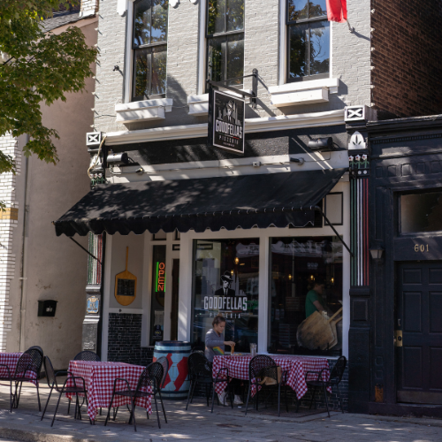 Exterior of Goodfellas Pizzeria Mainstrasse with hanging sign on the building.