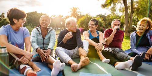 group of elderly people sitting outside together