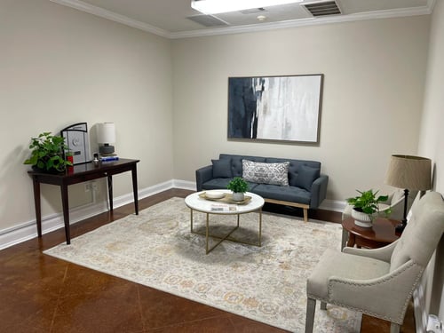 Tan walls with brown floor and gray chair
