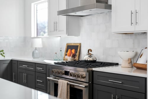 Modern dark shaker style custom kitchen cabinets with white quartz countertops
